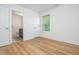 Bedroom featuring hardwood floors, a window, and an ensuite bathroom, offering a comfortable retreat at 1013 Liberty Springs Dr, Woodstock, GA 30188