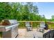 Outdoor deck with a stainless steel grill and comfortable seating, perfect for outdoor entertaining at 1013 Liberty Springs Dr, Woodstock, GA 30188