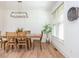 Well-lit dining room featuring a rustic wooden table, elegant lighting, and a decorative woven wall basket at 1013 Liberty Springs Dr, Woodstock, GA 30188
