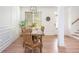 Inviting dining area with rustic wooden table and chairs with natural light beaming through the windows at 1013 Liberty Springs Dr, Woodstock, GA 30188