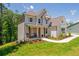 Beautiful two-story home with a combination of painted brick and siding and a well-manicured lawn on a sunny day at 1013 Liberty Springs Dr, Woodstock, GA 30188
