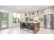 Bright eat-in kitchen with a large island, stainless steel appliances, and access to the outdoor patio at 1013 Liberty Springs Dr, Woodstock, GA 30188
