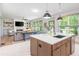 Eat-in kitchen overlooking the living area, featuring stainless steel appliances, and a large center island at 1013 Liberty Springs Dr, Woodstock, GA 30188