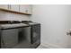 Laundry room equipped with modern, stainless steel washer and dryer units at 1013 Liberty Springs Dr, Woodstock, GA 30188