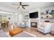 Open-concept living room features a fireplace, built-in shelves, and seamless flow to the dining area at 1013 Liberty Springs Dr, Woodstock, GA 30188