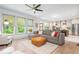 Bright, open living space with large windows, a comfortable sectional, and an inviting kitchen area at 1013 Liberty Springs Dr, Woodstock, GA 30188