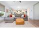 Inviting living room with comfortable sectional, ottoman, and open layout flows into the kitchen at 1013 Liberty Springs Dr, Woodstock, GA 30188