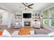 Inviting living room with fireplace and built-ins, filled with light from large windows, offers a cozy retreat at 1013 Liberty Springs Dr, Woodstock, GA 30188