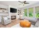 Bright living room boasts fireplace, built-in shelves, and large windows offering ample natural light at 1013 Liberty Springs Dr, Woodstock, GA 30188