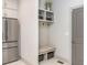 Mudroom with built-in storage, seating, and direct access to the garage and kitchen at 1013 Liberty Springs Dr, Woodstock, GA 30188