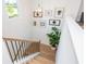 Bright stairway with wooden steps, black iron railings, and decorative wall art at 1013 Liberty Springs Dr, Woodstock, GA 30188