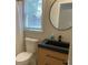 Bathroom with modern vanity, round mirror, shower with curtain, and sleek fixtures at 219 Maple Creek, Woodstock, GA 30188