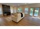 Spacious living room with fireplace, hardwood floors, and double doors to backyard at 219 Maple Creek, Woodstock, GA 30188