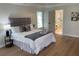 Comfortable main bedroom suite with hardwood floors, tray ceiling, and access to ensuite bathroom at 219 Maple Creek, Woodstock, GA 30188