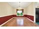 Formal dining room with hardwood floors, chair rail molding, chandelier, and window view at 2949 Spotted Pony Nw Ct, Acworth, GA 30101