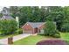 Charming brick home with a well-manicured lawn, mature trees, and an attached two-car garage at 2949 Spotted Pony Nw Ct, Acworth, GA 30101