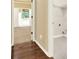 Hallway and laundry room with hardwood and tile floors at 2949 Spotted Pony Nw Ct, Acworth, GA 30101