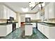 Kitchen featuring white cabinets, black appliances, and an island for meal preparation at 2949 Spotted Pony Nw Ct, Acworth, GA 30101
