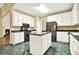 Spacious kitchen with white cabinets, island, and stainless steel appliances next to the living room fireplace at 2949 Spotted Pony Nw Ct, Acworth, GA 30101