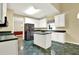 Bright kitchen with white cabinets, black appliances, and an island for extra counter space at 2949 Spotted Pony Nw Ct, Acworth, GA 30101