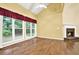 Bright living room featuring a fireplace, large windows, and hardwood floors at 2949 Spotted Pony Nw Ct, Acworth, GA 30101