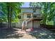 Spacious backyard featuring a deck with stairs, mature trees, and ample space for outdoor activities at 3006 Durban Ct, Decatur, GA 30034