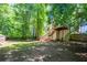 Expansive backyard with mature trees, a deck with stairs, and plenty of room to relax and entertain at 3006 Durban Ct, Decatur, GA 30034