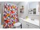 Cozy bathroom with a floral shower curtain, decorative shelves, and a modern vanity at 3006 Durban Ct, Decatur, GA 30034