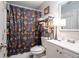 Bathroom featuring a floral patterned shower curtain, white vanity, and ample storage at 3006 Durban Ct, Decatur, GA 30034