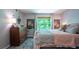 Bedroom featuring a vintage dresser, large window, and inviting patterned bedding at 3006 Durban Ct, Decatur, GA 30034