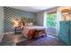 Comfortable bedroom with patterned wallpaper, a decorative headboard, and bright natural light from a large window at 3006 Durban Ct, Decatur, GA 30034