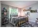 Bedroom with iron bed, decorator pillows, and stylish bookshelf and window at 3006 Durban Ct, Decatur, GA 30034
