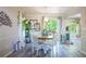 Cozy dining area with a wooden table, white chairs, and view of backyard at 3006 Durban Ct, Decatur, GA 30034