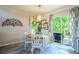 Cozy dining area with a wooden table, white chairs, and access to the outdoor deck at 3006 Durban Ct, Decatur, GA 30034