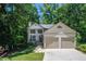Charming two-story home featuring a two-car garage, well-manicured lawn, and a welcoming front porch at 3006 Durban Ct, Decatur, GA 30034