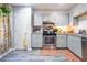 Bright kitchen featuring light gray cabinets, subway tile backsplash, and modern stainless steel oven and range at 3006 Durban Ct, Decatur, GA 30034