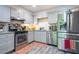 Modern kitchen with stainless steel appliances, gray cabinets, and ample counter space at 3006 Durban Ct, Decatur, GA 30034