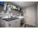 Laundry room featuring gray flooring, a modern washer and dryer, and convenient storage shelves at 3006 Durban Ct, Decatur, GA 30034