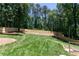 Large backyard featuring a new wood fence and lush lawn at 510 Whistlestop Dr, Woodstock, GA 30189