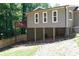 Back of house shows raised deck, partially finished basement, and sloping backyard at 510 Whistlestop Dr, Woodstock, GA 30189