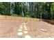 Backyard features stepping stones and a newly constructed wood fence at 510 Whistlestop Dr, Woodstock, GA 30189
