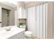 Clean bathroom features a vanity, toilet, and shower with a built-in organizer at 510 Whistlestop Dr, Woodstock, GA 30189
