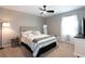 Neutral bedroom with natural light, modern fan, and full size bed at 510 Whistlestop Dr, Woodstock, GA 30189