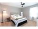 Well-lit bedroom features a ceiling fan, neutral colors, and comfortable bedding at 510 Whistlestop Dr, Woodstock, GA 30189