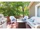 Outdoor deck featuring grill, cushioned wicker furniture, and a cozy gas fire pit at 510 Whistlestop Dr, Woodstock, GA 30189