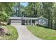 Charming single-story home with a well-maintained lawn and attached two-car garage at 510 Whistlestop Dr, Woodstock, GA 30189