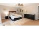 Well lit bedroom with ceiling fan, artwork, neutral walls and a sleek dresser at 510 Whistlestop Dr, Woodstock, GA 30189