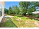 Large, green backyard featuring healthy green grass and mature trees at 5125 Winding Glen Dr, Lithonia, GA 30038