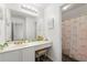 Bathroom features white cabinets, ample counter space, and a shower with a pretty pink bow curtain at 5125 Winding Glen Dr, Lithonia, GA 30038