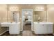 Well-lit primary bathroom with separate vanities, tile floor, and walk-in to bedroom at 5125 Winding Glen Dr, Lithonia, GA 30038